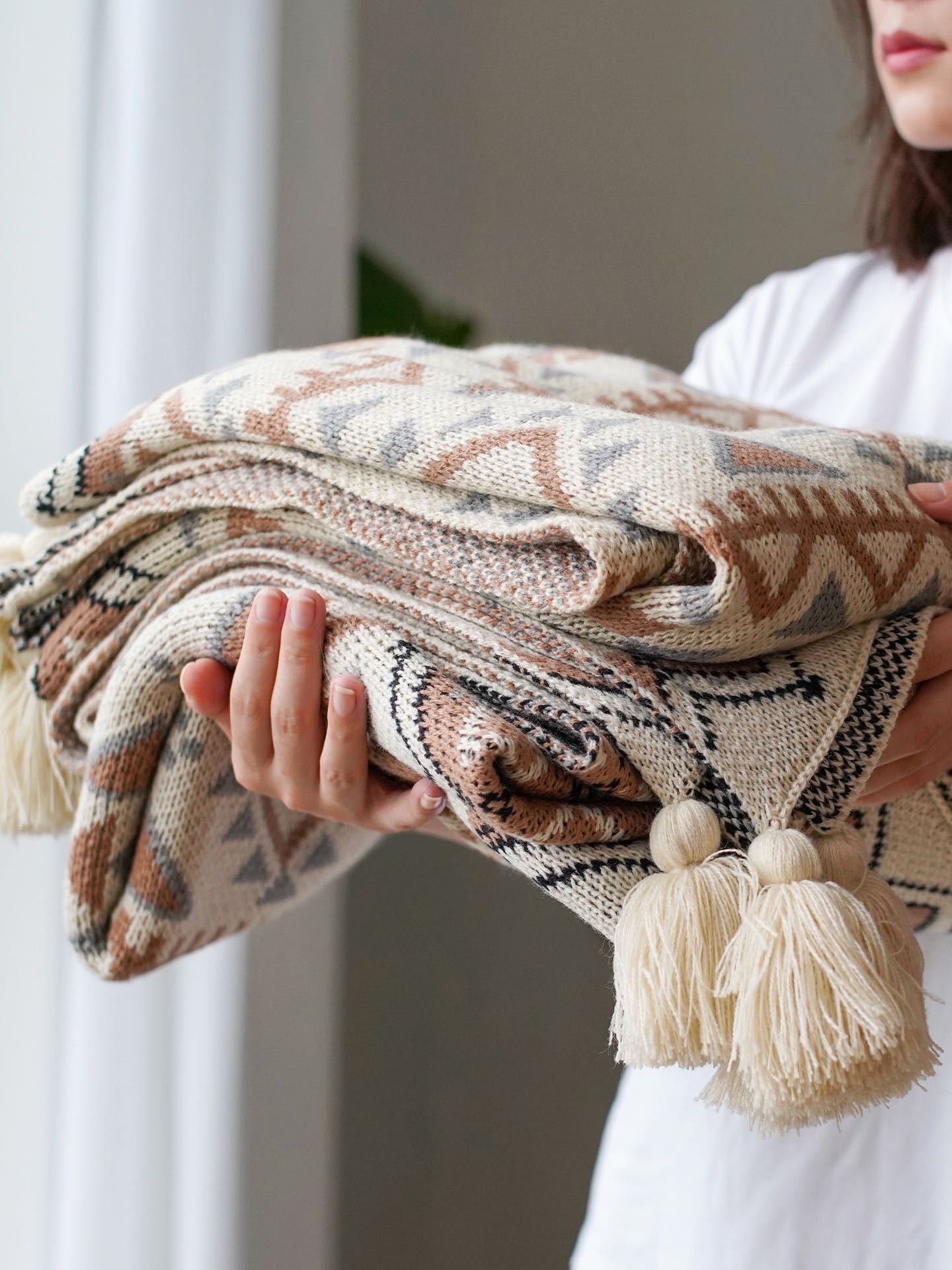 boho acrylic white throw blanket held by a woman