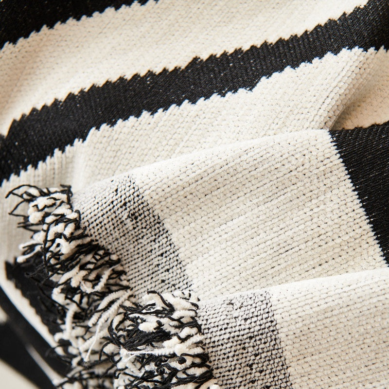Close-up of a black and white striped fabric boho sofa cover throw